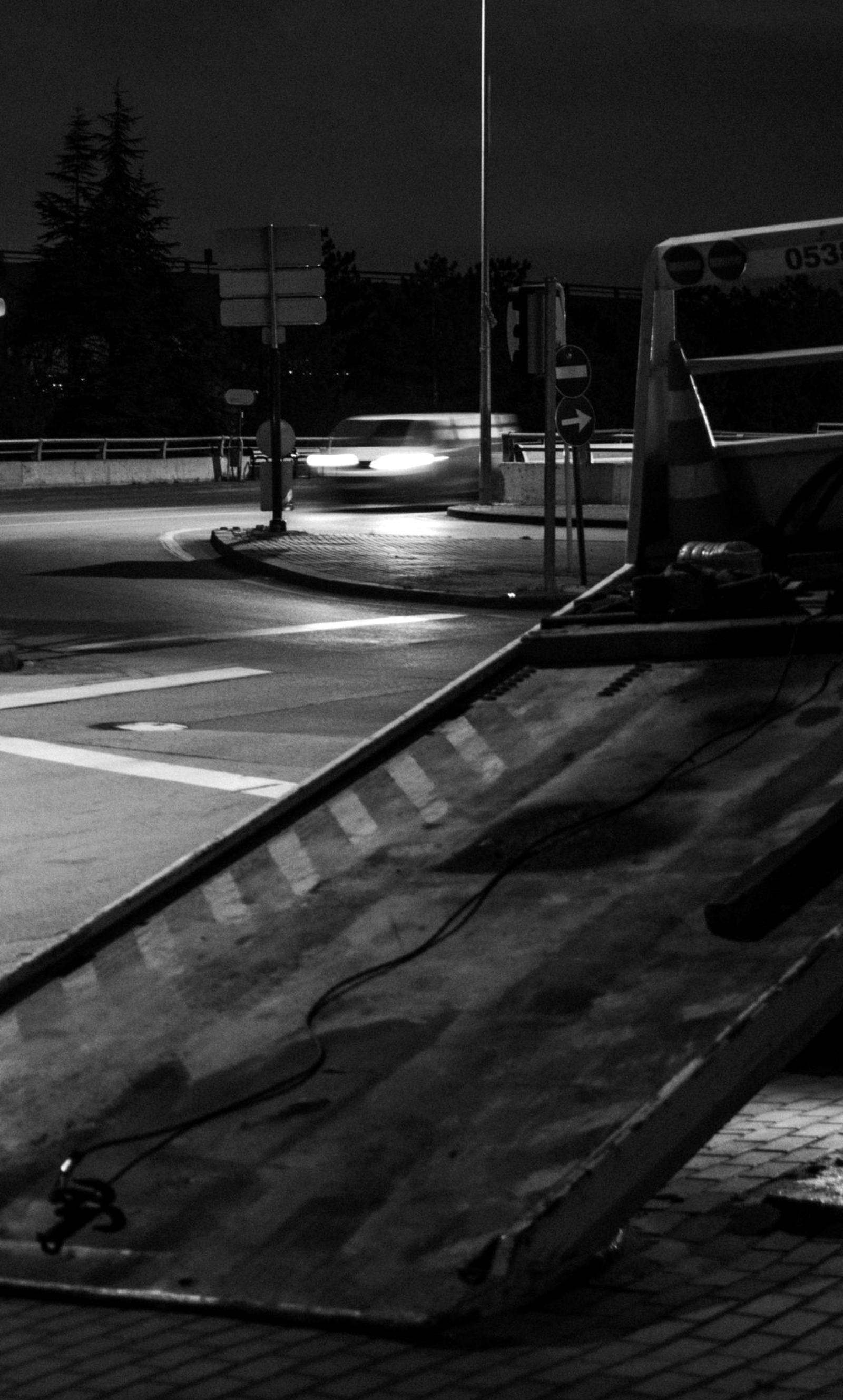 A tilt tray deck lowered under a streetlight at night